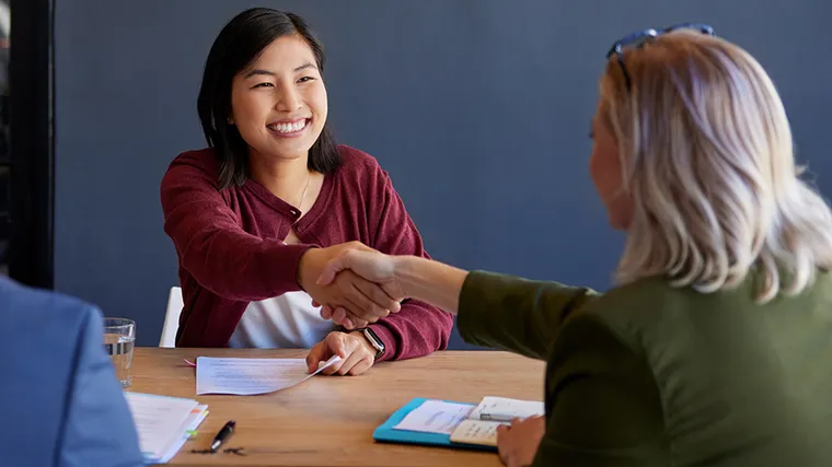 Picture of two women shaking hands. 